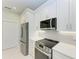 Modern kitchen with stainless steel appliances and white cabinets at 8380 Malcolm Ave, North Port, FL 34287