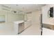 Modern kitchen features white cabinets, stainless steel appliances, and an island at 8380 Malcolm Ave, North Port, FL 34287