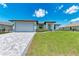 Modern home with gray garage door and paved driveway at 8380 Malcolm Ave, North Port, FL 34287