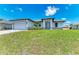 Single-story home with a gray garage door and driveway at 8380 Malcolm Ave, North Port, FL 34287