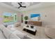 Living room with comfortable seating, large TV, and sliding glass doors leading to patio at 8380 Malcolm Ave, North Port, FL 34287
