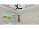 Spacious living area with light walls, ceiling fan, and sliding glass doors at 8380 Malcolm Ave, North Port, FL 34287