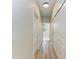 Light-filled hallway with wood-look floors and ample closet space at 8380 Malcolm Ave, North Port, FL 34287