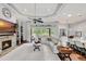 Spacious living room featuring a fireplace, built-in shelving, and large windows at 13721 Palazzo Ter, Bradenton, FL 34211