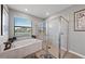 Beautiful bathroom featuring a separate soaking tub and glass enclosed shower at 15739 Barefoot Beach Dr, Bradenton, FL 34211