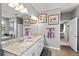Bright bathroom featuring double sinks with granite counters and modern fixtures at 15739 Barefoot Beach Dr, Bradenton, FL 34211