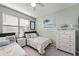 Charming bedroom with twin beds, decorated with a coastal theme and cheerful colors at 15739 Barefoot Beach Dr, Bradenton, FL 34211