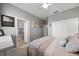 Cozy bedroom with a closet, ceiling fan, neutral walls, and a bed with patterned bedding at 15739 Barefoot Beach Dr, Bradenton, FL 34211