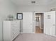 Bedroom featuring a coastal theme with a dresser, decor and access to the bathroom at 15739 Barefoot Beach Dr, Bradenton, FL 34211