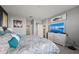 Comfortable bedroom features a large bed, dresser with TV and beach themed decor at 15739 Barefoot Beach Dr, Bradenton, FL 34211