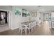 Cozy dining room with wooden table and natural light, adjacent to kitchen at 15739 Barefoot Beach Dr, Bradenton, FL 34211