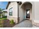 Inviting front entrance features a stone-accented exterior and a dark wood front door at 15739 Barefoot Beach Dr, Bradenton, FL 34211