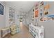 Hallway with gray walls and tiled floors, decorated with an eclectic collection of framed photos and art at 15739 Barefoot Beach Dr, Bradenton, FL 34211