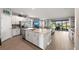 Spacious open kitchen featuring stainless steel appliances and large center island at 15739 Barefoot Beach Dr, Bradenton, FL 34211