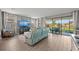 Stylish living room with tile floors, a light blue leather couch, and large sliding glass doors to the outdoor patio at 15739 Barefoot Beach Dr, Bradenton, FL 34211