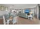 Open concept living and dining with stainless kitchen and view to screened lanai at 15739 Barefoot Beach Dr, Bradenton, FL 34211