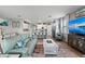 Inviting living space seamlessly integrates a modern kitchen and dining area, complete with tile floors and bright recessed lighting at 15739 Barefoot Beach Dr, Bradenton, FL 34211