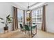 Bright dining room with glass table, emerald green chairs, and large windows at 8005 Tybee Ct # 8005, University Park, FL 34201