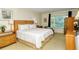 King-size bed in a well-lit main bedroom with wood furniture at 100 Sands Point Rd # 324, Longboat Key, FL 34228