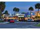 Evening street scene with shops and palm trees along a well-lit street at 100 Sands Point Rd # 324, Longboat Key, FL 34228