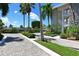 Elegant entrance with stonework and tropical landscaping at 100 Sands Point Rd # 324, Longboat Key, FL 34228