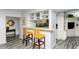 Condo kitchen with breakfast bar and two wicker stools at 100 Sands Point Rd # 324, Longboat Key, FL 34228