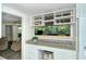 Kitchen with breakfast bar and view; white cabinets and granite counters at 100 Sands Point Rd # 324, Longboat Key, FL 34228