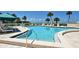 Inviting community pool with lounge chairs and ocean views at 100 Sands Point Rd # 324, Longboat Key, FL 34228