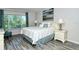 Bright bedroom with king-size bed, window, and tile flooring at 100 Sands Point Rd # 324, Longboat Key, FL 34228