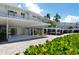 Modern building with covered parking and lush landscaping at 100 Sands Point Rd # 324, Longboat Key, FL 34228