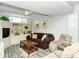 Relaxing living room featuring a brown couch and built-in shelving at 100 Sands Point Rd # 324, Longboat Key, FL 34228
