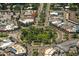Aerial view of a town center with shops and a circular park at 100 Sands Point Rd # 324, Longboat Key, FL 34228