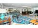 Open living area with teal sofas and a view of the dining area at 100 Sands Point Rd # 324, Longboat Key, FL 34228