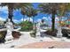 White statues in a lush, tropical park setting with palm trees and paved walkways at 100 Sands Point Rd # 324, Longboat Key, FL 34228