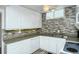 Updated kitchen featuring white cabinets and granite countertops at 100 Sands Point Rd # 324, Longboat Key, FL 34228