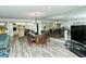 Open concept dining room with large glass table and leather chairs at 100 Sands Point Rd # 324, Longboat Key, FL 34228