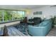 Living room with wood-look floors, large windows and comfortable seating at 100 Sands Point Rd # 324, Longboat Key, FL 34228