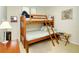 Bedroom with twin-over-twin bunk bed and built in shelving at 100 Sands Point Rd # 324, Longboat Key, FL 34228
