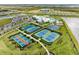 Aerial view of community amenities including pool, tennis, and basketball courts at 15739 Barefoot Beach Dr, Bradenton, FL 34211