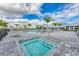 Community pool and hot tub with palm trees at 15739 Barefoot Beach Dr, Bradenton, FL 34211