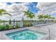 Relaxing hot tub surrounded by lounge chairs at 15739 Barefoot Beach Dr, Bradenton, FL 34211