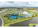 Aerial view of community amenities including pool, tennis, and basketball courts at 15739 Barefoot Beach Dr, Bradenton, FL 34211