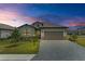 One-story home with gray exterior and paver driveway at 15739 Barefoot Beach Dr, Bradenton, FL 34211