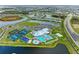 Aerial view of community with resort-style pool and sports courts at 15739 Barefoot Beach Dr, Bradenton, FL 34211