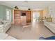 Bright living room with built-in shelving and tile floors at 334 Circlewood Dr # E3-2, Venice, FL 34293