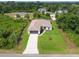 Aerial view of a beautiful home with a pool, large yard, and mature trees at 2511 Stagnaro Rd, North Port, FL 34287
