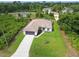 Aerial view of house featuring a covered patio, well-maintained lawn, and attached garage at 2511 Stagnaro Rd, North Port, FL 34287