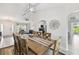 Bright dining room leads to an open living area and kitchen, complemented by a modern light fixture and decor at 2511 Stagnaro Rd, North Port, FL 34287