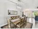 Bright dining room features modern light fixtures, wooden table and decor at 2511 Stagnaro Rd, North Port, FL 34287