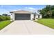 Charming single-story home showcasing a well-manicured lawn and a spacious two-car garage at 2511 Stagnaro Rd, North Port, FL 34287